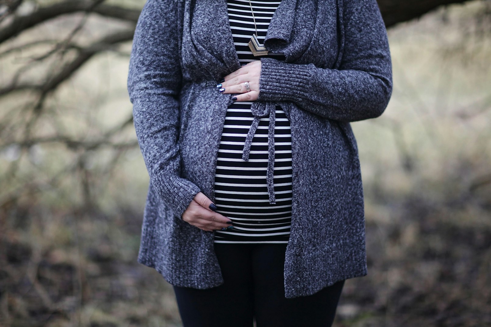 Woman pregnant in black and white striped shirt standing 952597 1